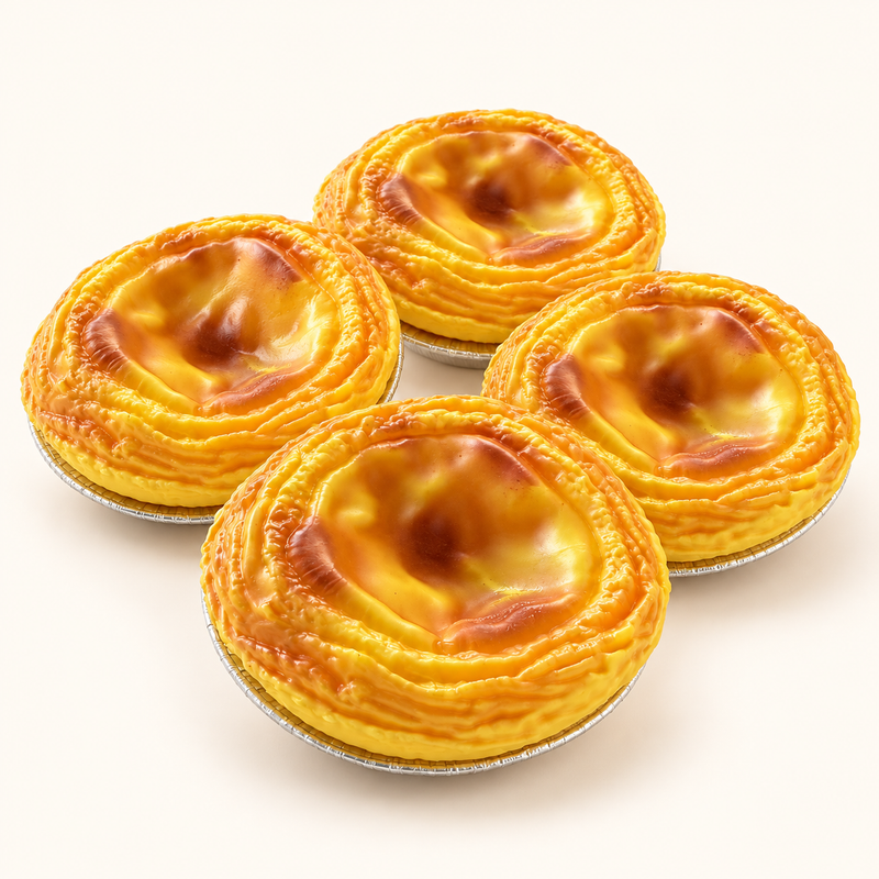Four SQUEEZU Egg Tart Squishy toys with golden pastry edges and glossy custard centers.