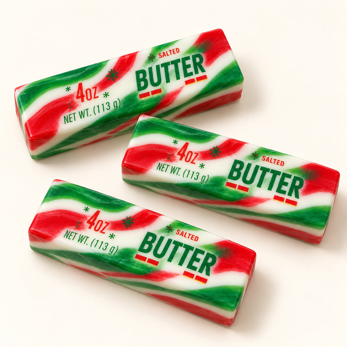 Three SQUEEZU Christmas Swirl Butter Bar Squishy toys with red, green and white stripes.
