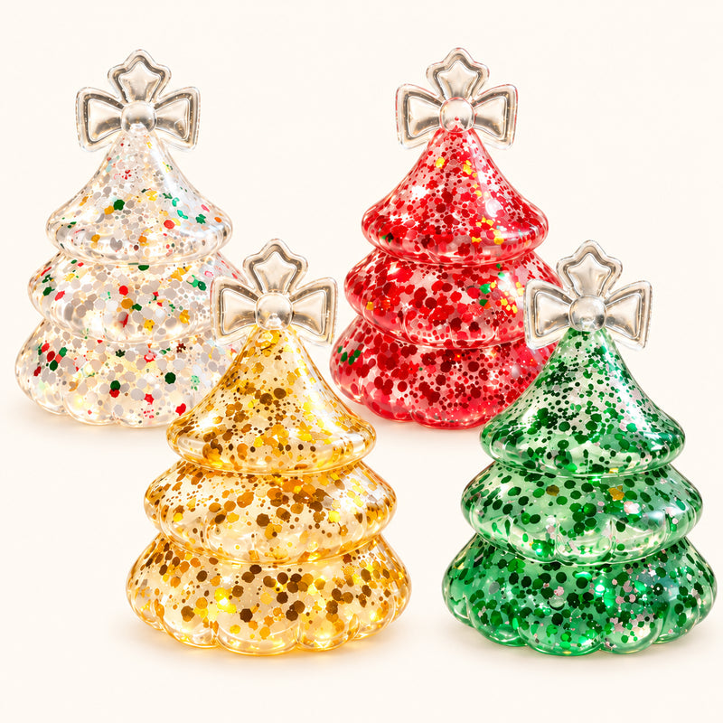 Clear, red, green and yellow SQUEEZU Glitter Christmas Tree Squishy toys with bow-shaped tops.