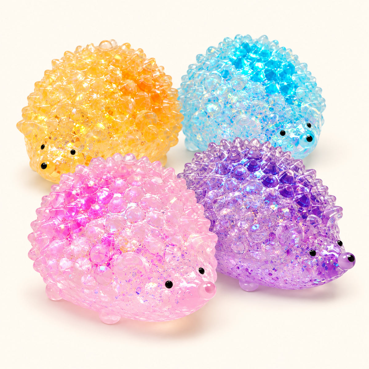 Yellow, blue, pink and purple SQUEEZU Glitter Hedgehog Squishy toys with raised glitter-filled spines.