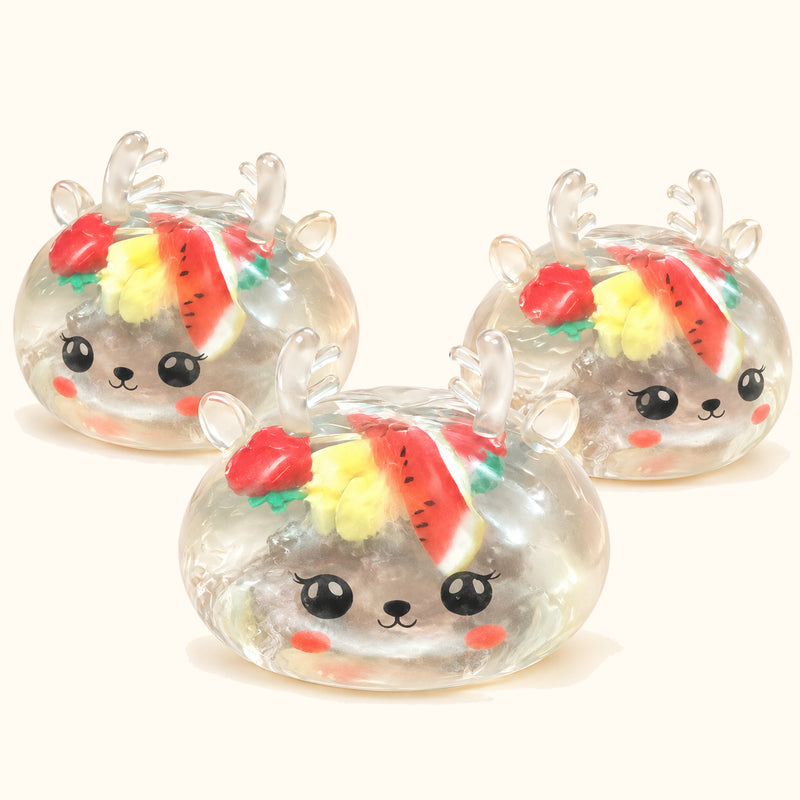 Three clear SQUEEZU Reindeer Fruit Bun Squishy toys with antlers, smiling faces and fruit-shaped decorations.