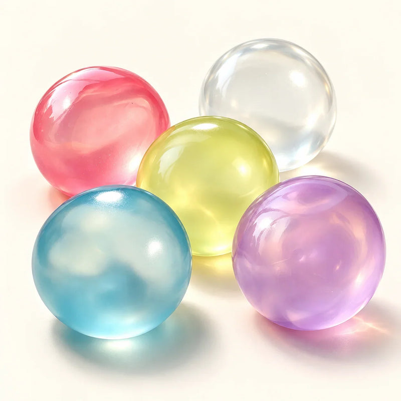 SQUEEZU Translucent Ball Squishy toys in pink, clear, yellow, blue and purple.