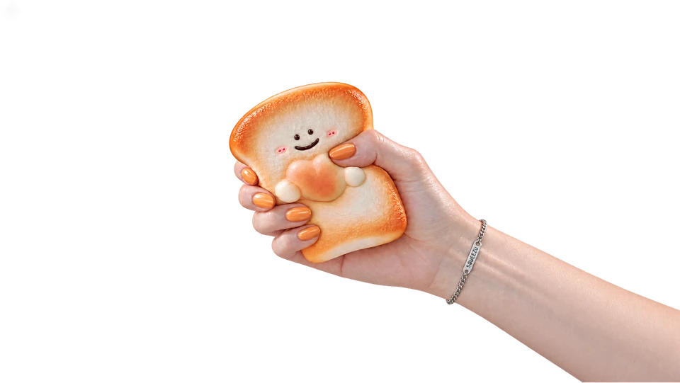 A hand squeezing a smiling toast SQUEEZU
